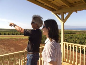 Christina and MauiGrown farm owner Kimo Falconer overlooking the orchard. Photo courtesy of Zachary Ethier.